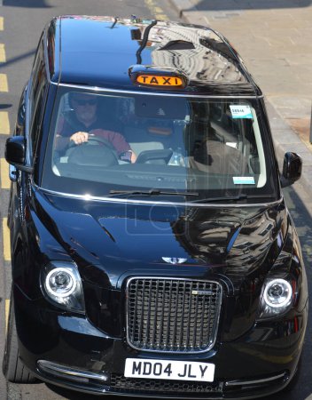 Photo for LONDON UNITED KINGDOM 06 19 2023: "Black cabs" were traditionally coloured black, but this is not a requirement and cabs are painted in other colours, sometimes bearing advertising - Royalty Free Image