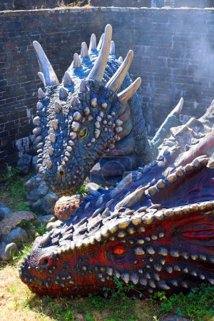 Photo for CAERPHILLY CASTLE SOUTH WALES UNITED KINGDOM 6 19 2023: Game of thrones dragons who broke the banks of Caerphilly Castle ( Welsh: Castell Caerffili) is a medieval fortification - Royalty Free Image