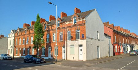 Photo for BELFAST NORTHERN IRELAND UNITED KINGDOM 06 03 2023: Belfast's traditional red brick Victorian Terraced houses in being flattened for bland housing with little merit - Royalty Free Image