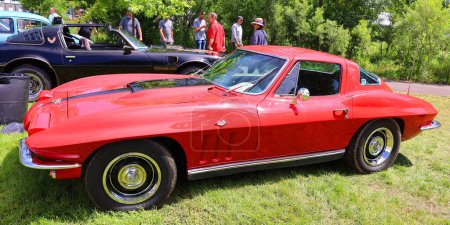 Photo for GRANBY QUEBEC CANADA 07 30 23: Chevrolet Corvette 1966 is the second generation of the Corvette sports car, produced by the Chevrolet division of General Motors (GM) for the 1963 through 1967 model - Royalty Free Image