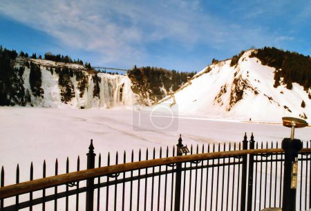 Photo for In winter the Montmorency Falls (French: Chute Montmorency) is a large waterfall on the Montmorency River in Quebec, Canada. Cold weather conditions make this area popular with climbers and hikers - Royalty Free Image