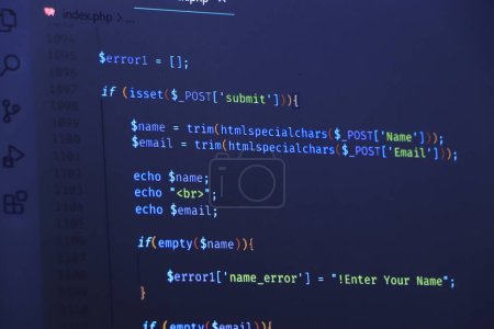 The software developer is doing php coding. Abstract code background. Selective focus code on computer screen