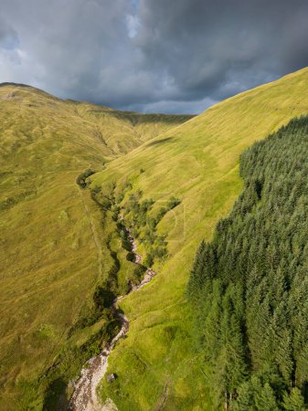 Aerial view of mountains with green grass and forest at Auch, Bridge of Orchy, Scottish Highlands