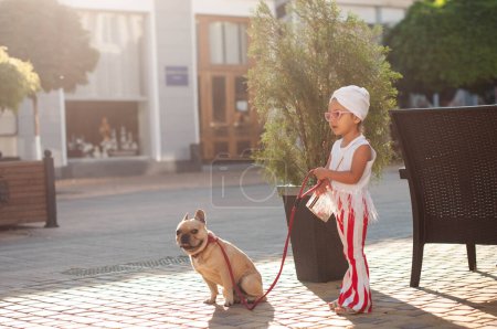 Little cute girl with french bulldog 