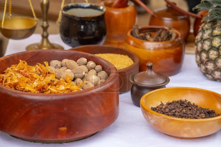 Wooden bowls with spices, cinnamon, cardamom, cloves, nutmeg, close up, ceramics on a wooden table, focus on one bowl, still life. High quality photo