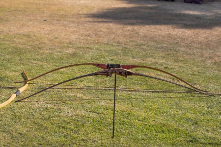 Photo for Medieval archery equipment, wooden bow and arrow. Medieval fair. High quality photo - Royalty Free Image