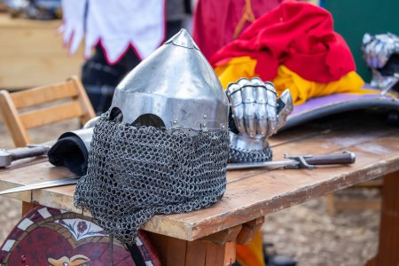 Elements of medieval iron knight armor for battle, helmet, spaulders, pouldrons, vambraces, gauntlets. Medieval fair. High quality photo