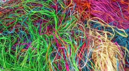 Multi-colored straw for weaving, materials for crafting, bright background. High quality photo