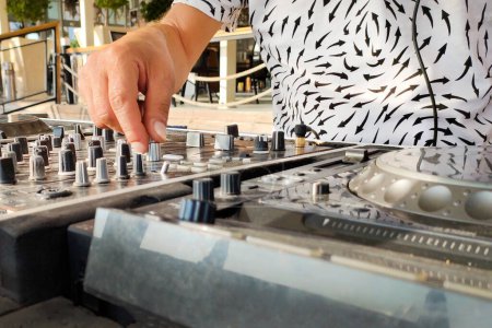 Photo for Turkey, Alanya - August 12, 2022: DJ creates music on mixing player, hands and mixer close-up - Royalty Free Image