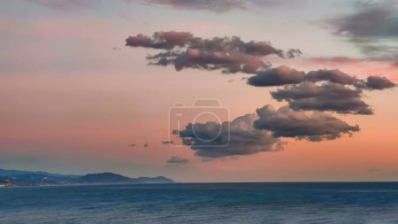 Photo for Pink and blue clouds in evening pink sky over sea, twilight fairy sunset, copy space. - Royalty Free Image