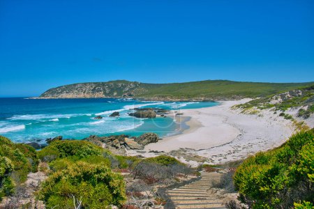 Turquoise sea, dunes and a footpath to the beach: West Beach, along the Hakea Trail in Fitzgerald River National Park, south coast of Western Australia.