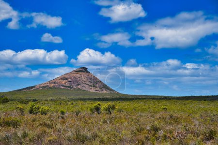 Photo for The iconic, granitic Frenchmans Peak rising up from the dense vegetation of the coastal plain in Cape Le Grand National Park, Western Australia. - Royalty Free Image