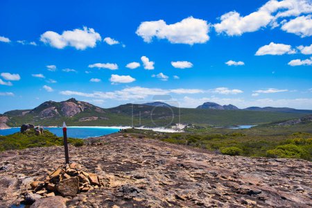 Photo for Trail marker along the Coastal Trail in Cape Le Grand National Park, Western Australia. View of granitic mountains, coastal vegetation and Thistle Cove - Royalty Free Image