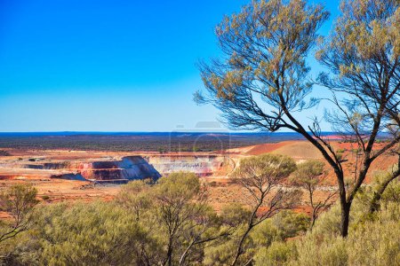 Open pit gold mine in the vast expanse of the Western Australian outback, close to the town of Mount Magnet