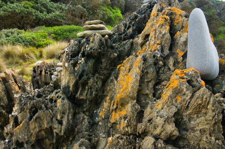 Contrasting textures, heavily eroded, lichen covered dark rock and smooth grey stone