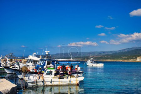 Kleine Fischerboote im Hafen von Agios Georgios am Kap Drepanum, Bezirk Paphos, Zypern. Im Hintergrund die Hügel der Halbinsel Akamas
