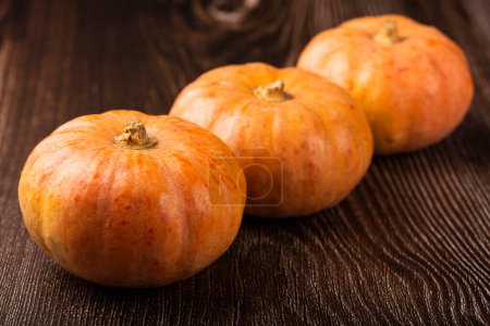 Photo for Pumpkins on the wooden table. - Royalty Free Image