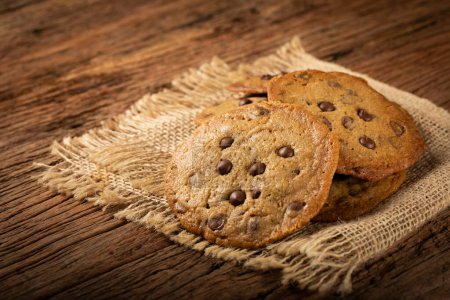 Photo for Delicious chocolate cookies on wooden table. - Royalty Free Image
