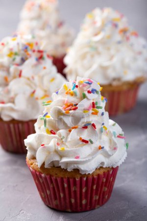 Photo for Tasty party cupcakes on the table. Cupcakes with whipped cream. - Royalty Free Image