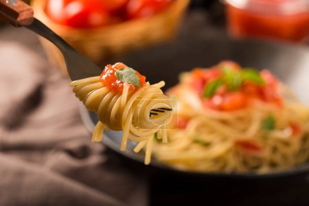 Photo for Dish with spaghetti in tomato sauce and basil. - Royalty Free Image