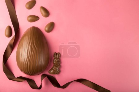 Photo for Easter. Composition with chocolate Easter eggs on pink background, space for text. - Royalty Free Image
