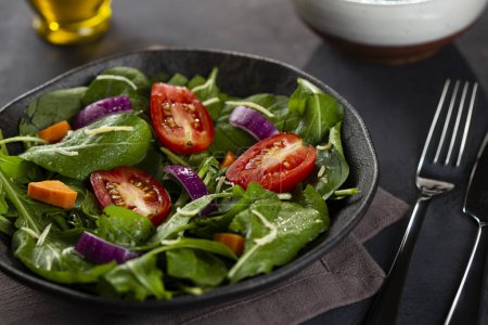Photo for Fresh arugula salad with tomatoes. - Royalty Free Image
