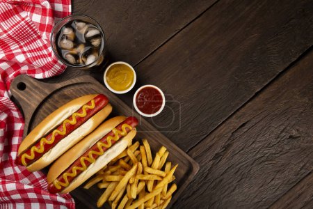 Hot dogs with french fries and soda. 