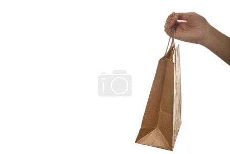 Photo for Holding paper shopping bag on white background. - Royalty Free Image