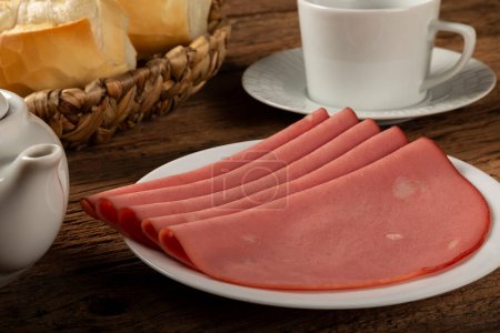 Photo for Plate with sliced mortadella on the table. - Royalty Free Image