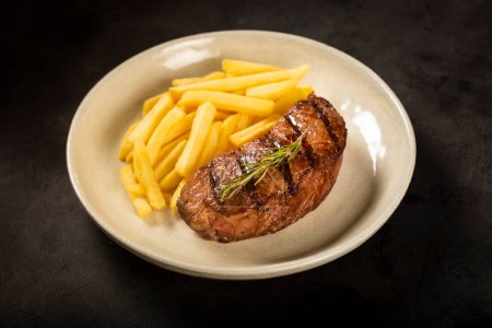 Photo for Dish with grilled steak and french fries. - Royalty Free Image