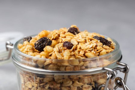Photo for Glass jar with granola on the table. - Royalty Free Image