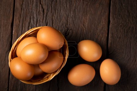 Photo for Basket with brown chicken eggs goes up the table. - Royalty Free Image