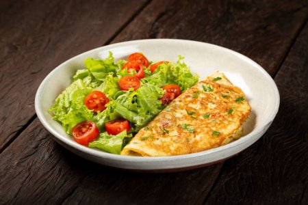 Photo for Omelet with cheese and lettuce and tomato salad. - Royalty Free Image