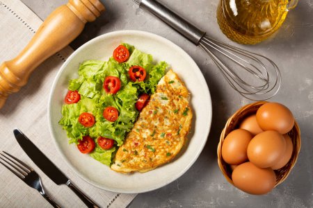 Omelet with cheese and lettuce and tomato salad.