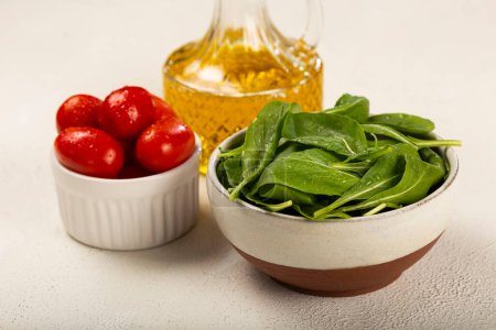 Photo for Arugula salad with tomatoes on white background. - Royalty Free Image