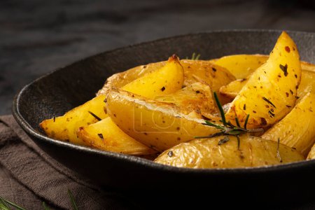 Photo for Roasted potatoes with rosemary on the plate. - Royalty Free Image