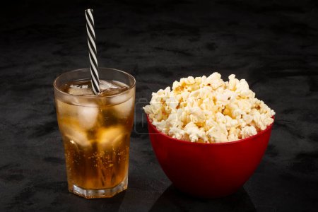 Photo for Bowl with salted popcorn and soda on the table. - Royalty Free Image