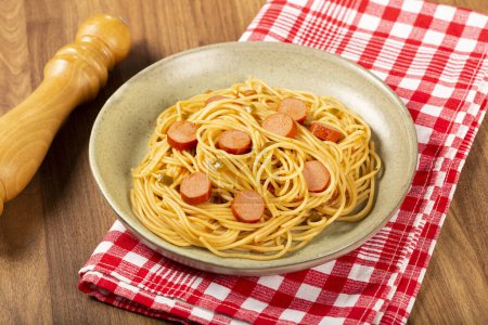 Spaghetti mit Wurstscheiben und Tomatensauce.