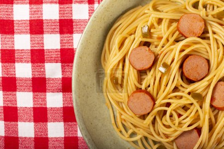 Photo for Spaghetti pasta with sliced sausage and tomato sauce. - Royalty Free Image