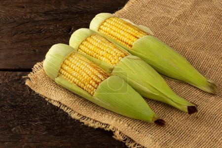 Photo for Green corn on the wooden table. - Royalty Free Image