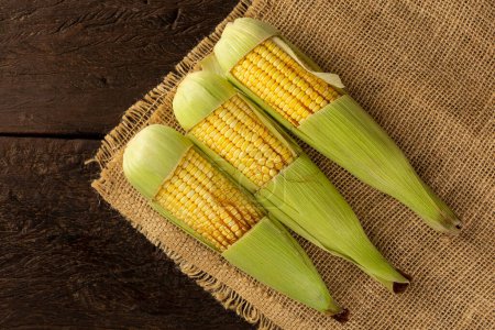 Photo for Green corn on the wooden table. - Royalty Free Image