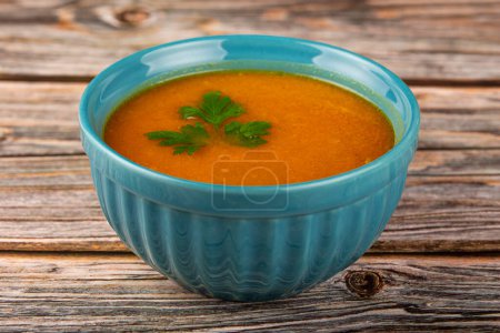 Delicious homemade pumpkin soup in bowl.