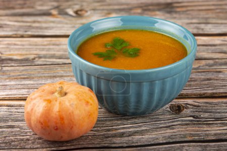 Delicious homemade pumpkin soup in bowl.