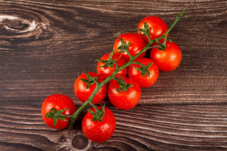 Photo for Ripe tomatoes on the wooden table. - Royalty Free Image