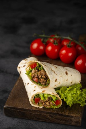 Mexican burritos stuffed with beef and salad.