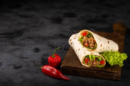 Photo for Mexican burritos stuffed with beef and salad. - Royalty Free Image