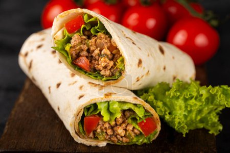 Mexican burritos stuffed with beef and salad.