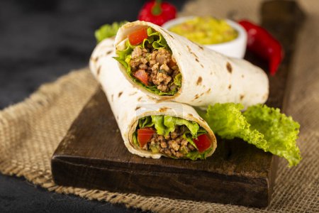 Photo for Mexican burritos stuffed with beef and salad. - Royalty Free Image