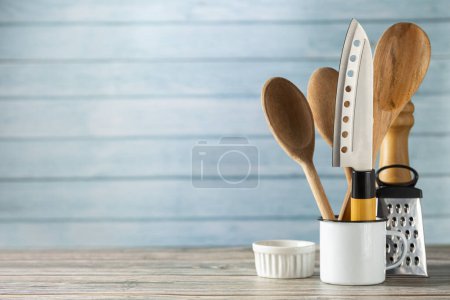 kitchen utensils on wooden background.