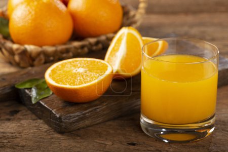 Glass with orange juice on the table.